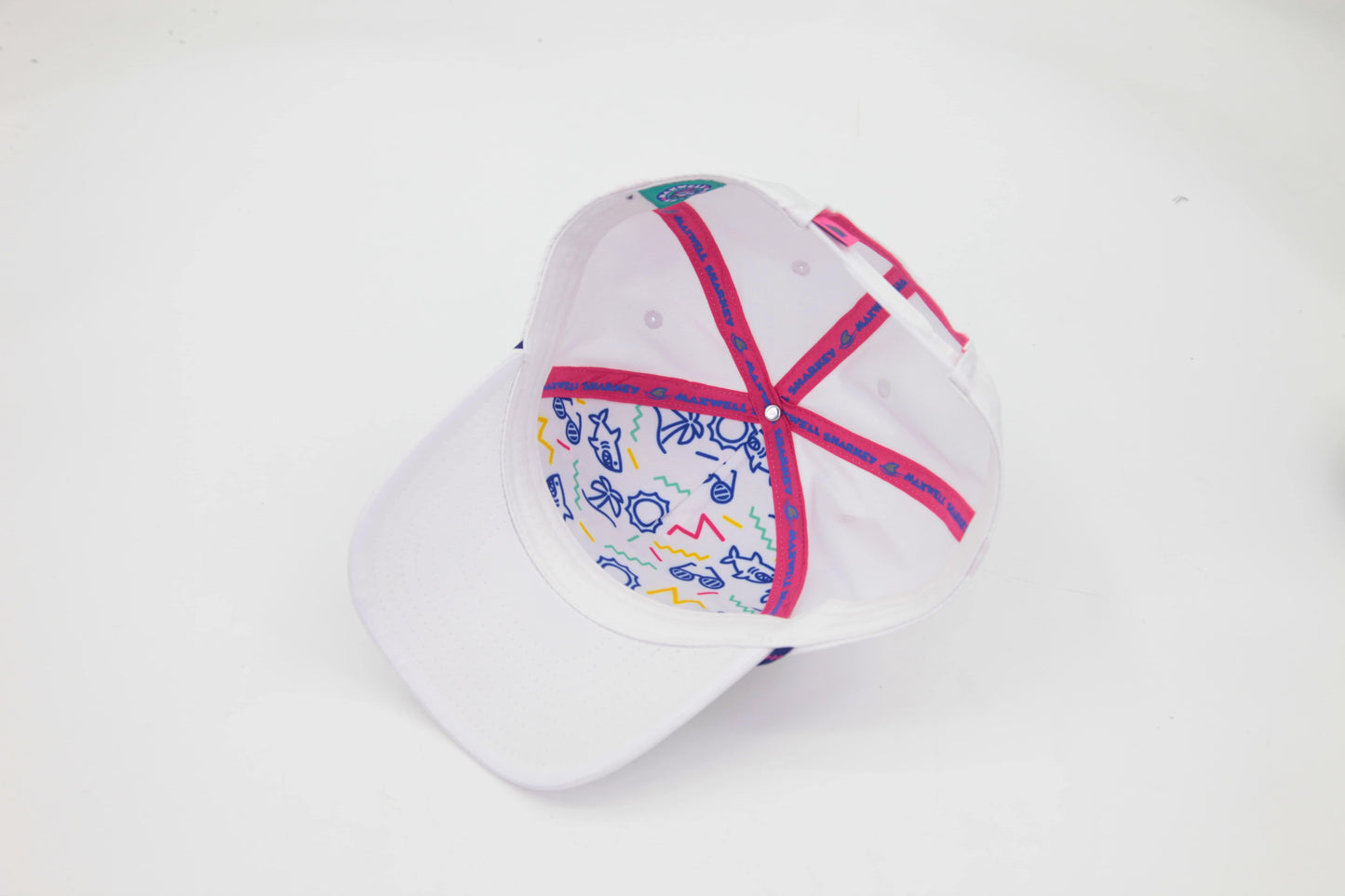 Underbrim view of The Ice Dangerous ’93 Hat – white interior with vibrant retro-style Maxwell Sharkey pattern print and pink Maxwell Sharkey logo taping.