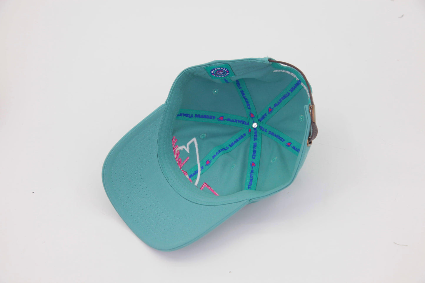 Underbrim view of The Sharkey Cruiser Hat – teal interior lined with tropical blue, teal and pink Maxwell Sharkey taping.