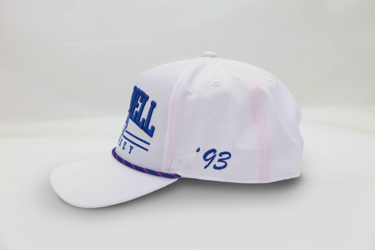 Side view of The Shark Attack Rope Hat – white cap with bold ‘93 embroidery in blue and contrast rope stitching on the brim.