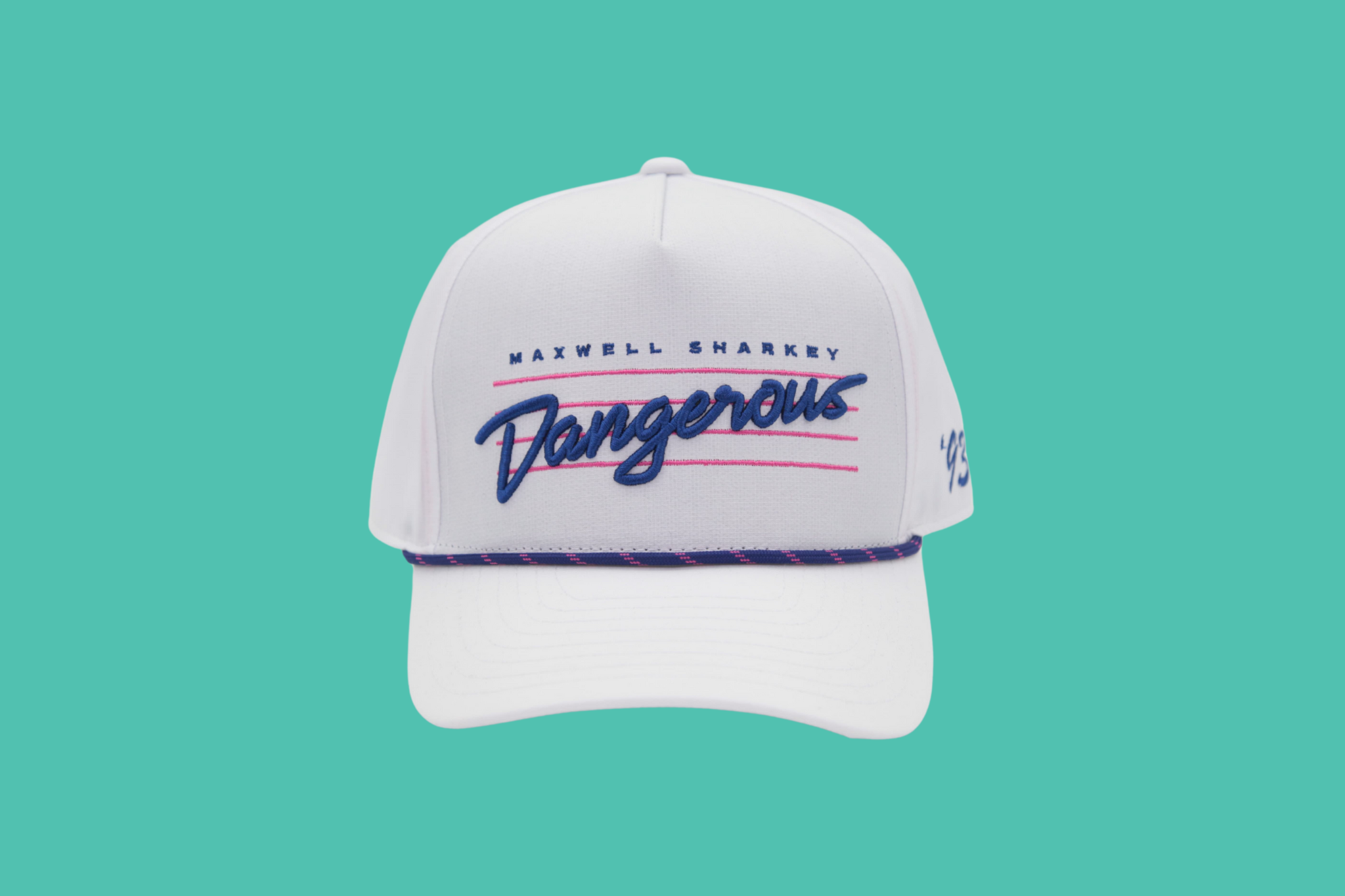 Maxwell Sharkey ‘Dangerous’ snapback hat in white with bold blue embroidered lettering, 90s-inspired rope detail, and a structured retro fit