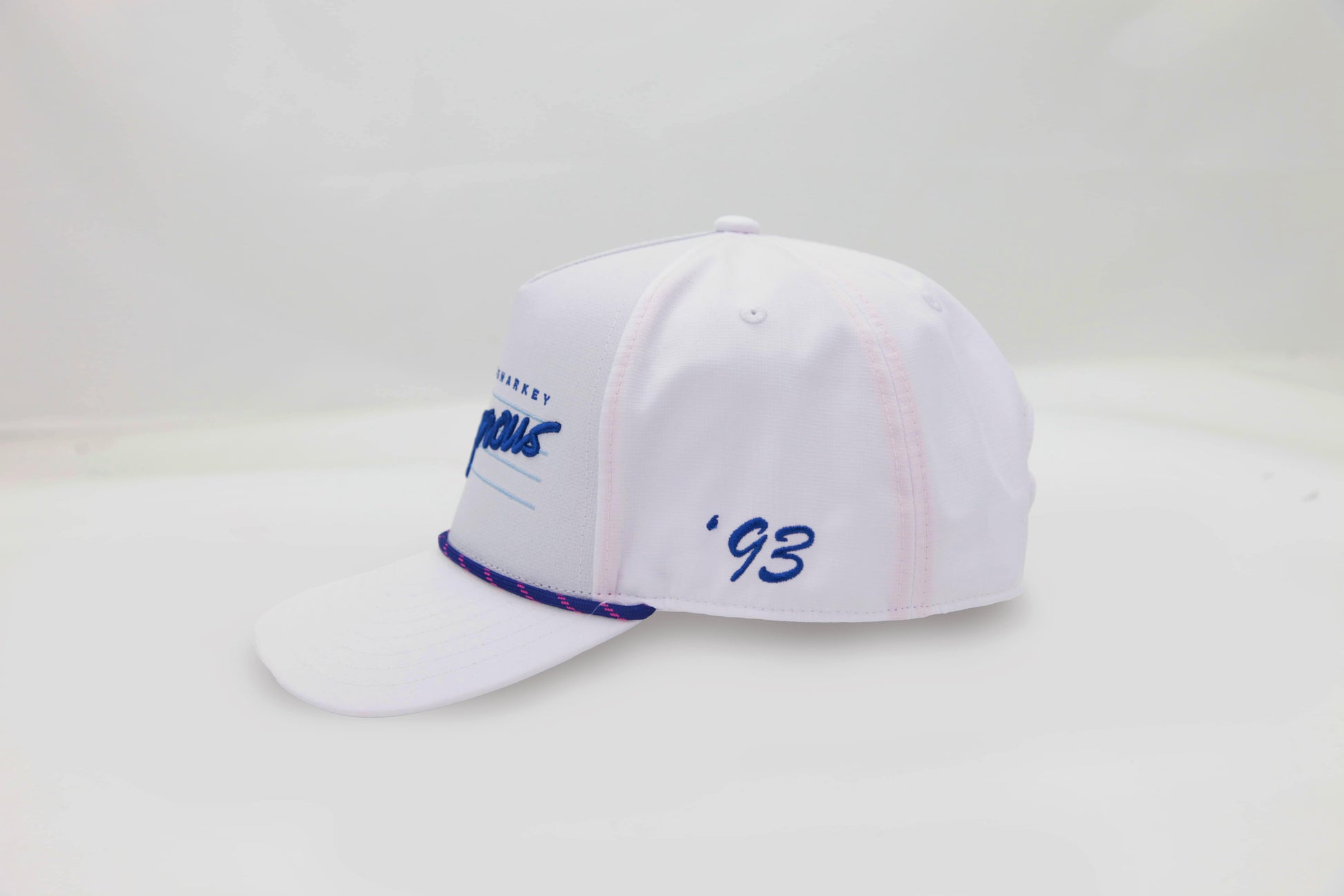 Side view of The Ice Dangerous ’93 Hat – clean white cap with blue ‘93 embroidery and bright blue and pink rope accent along brim.